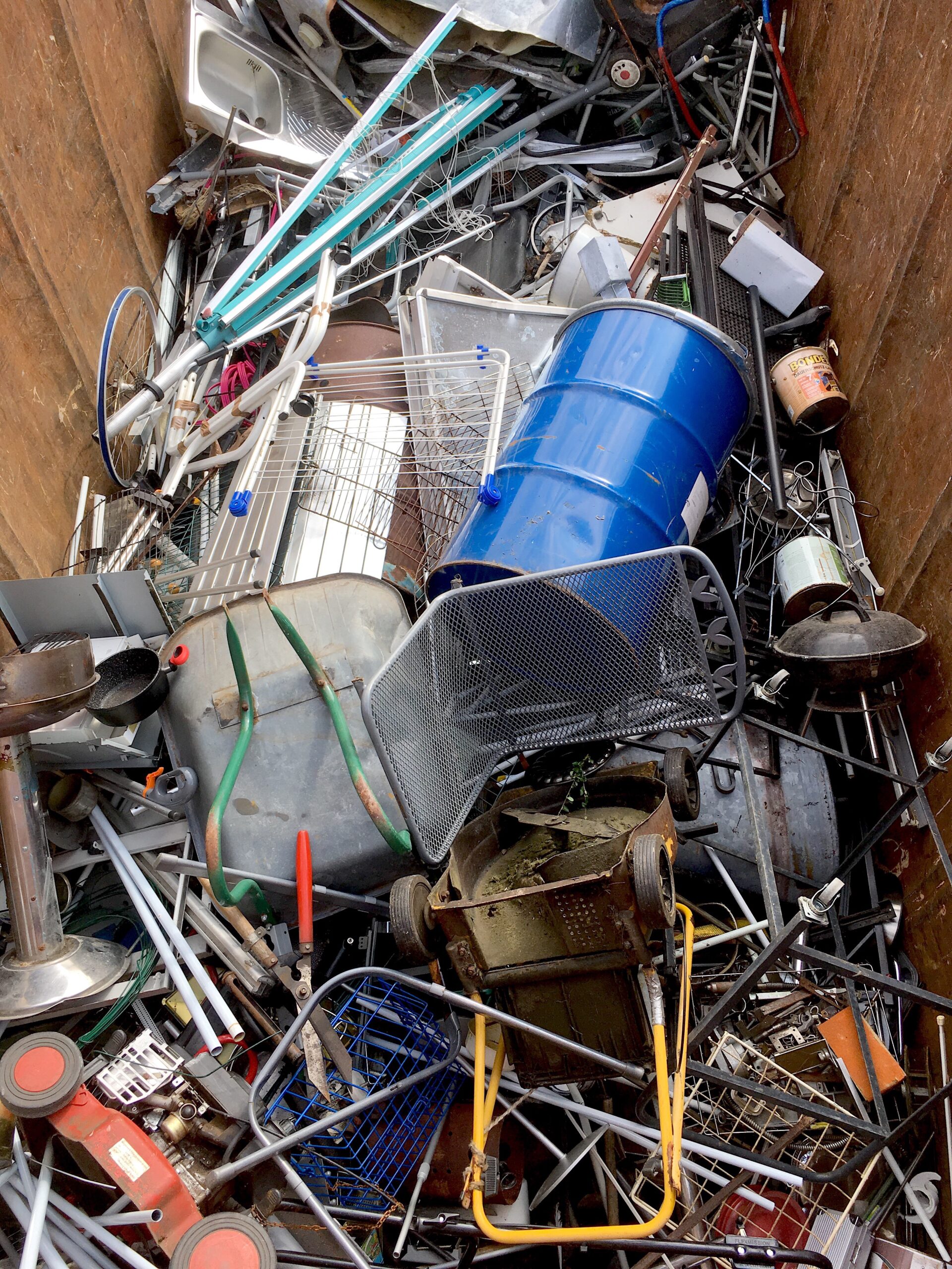 junk removal image (3) Mixed metal junk and discarded items piled in a dumpster during junk removal.
